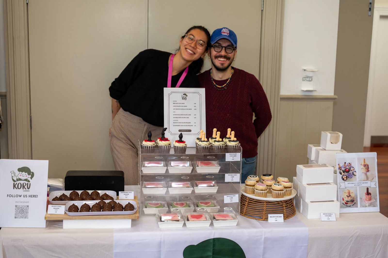 Cakes decorated with koru patterns on a stall