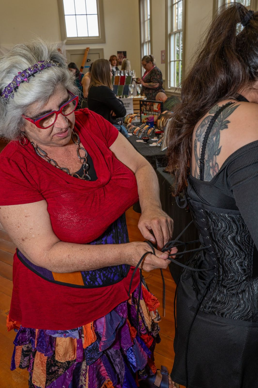 A corsetier fitting a guest